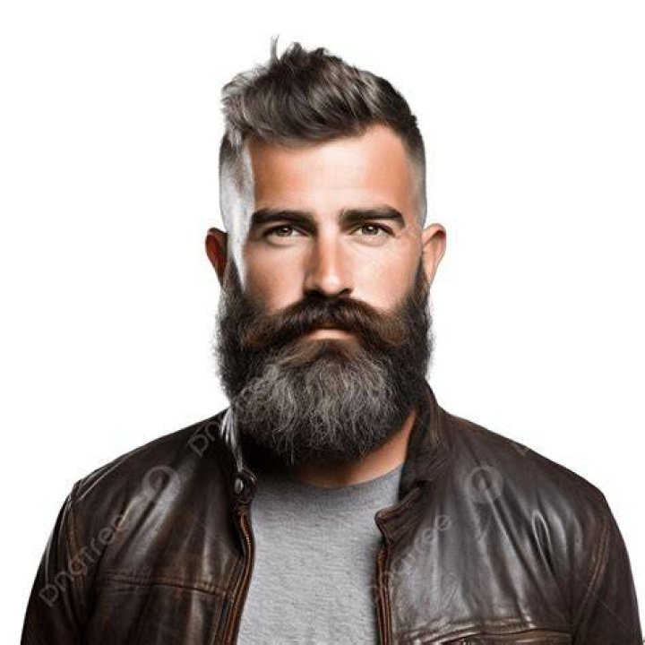 a bearded man with his arms crossed