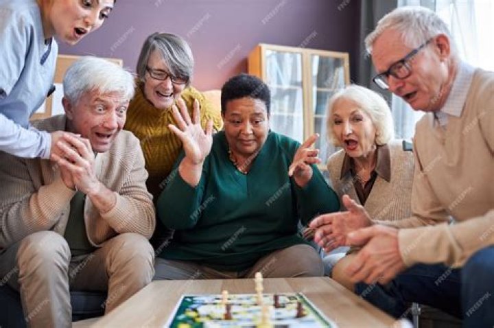 a group of seniors playing games together Giving Care by Silvert's