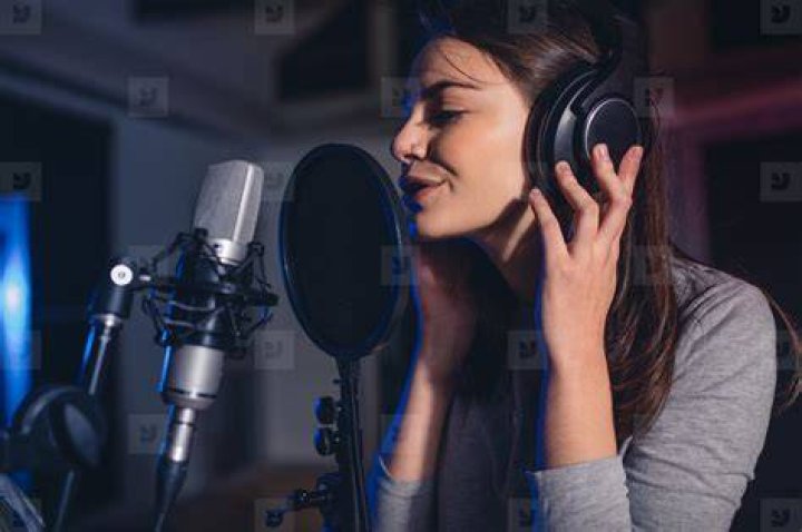Female vocal artist singing in a recording studio stock photo (132581
