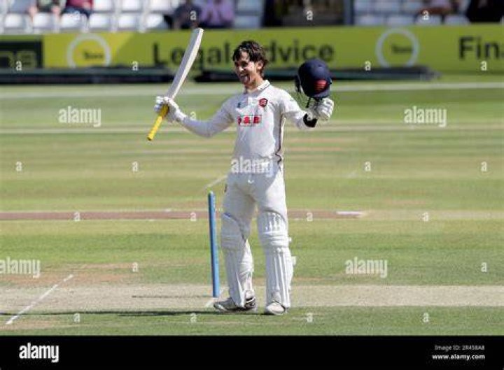 ImamulHaq raises his bat after completing his halfcentury